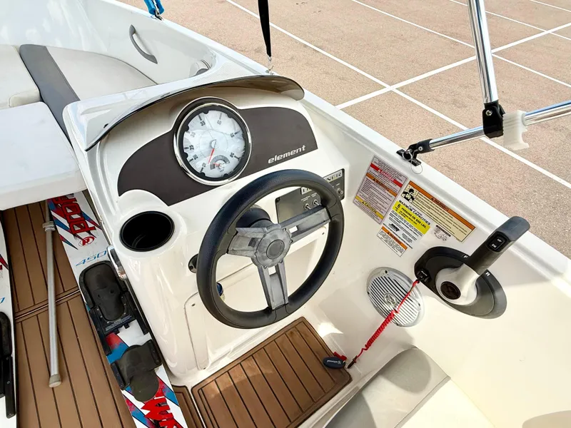 Slide: The Image of 2017 Bayliner Element E16 boat dashboard with steering wheel and control panel. - 11