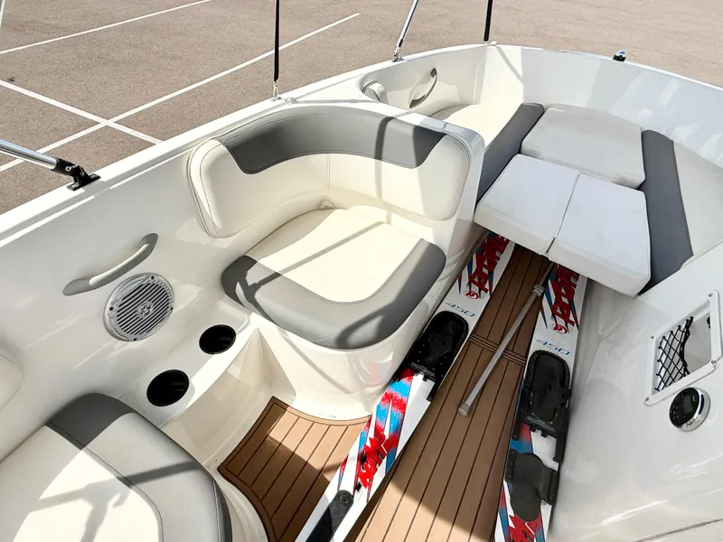 Slide: The Image of 2017 Bayliner Element E16 interior with seating, cup holders, and water skis. - 12