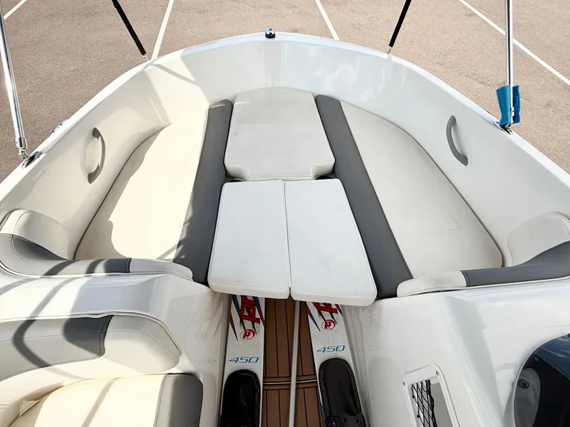 Slide: The Image of 2017 Bayliner Element E16 boat interior with cushioned seating and storage space. - 13