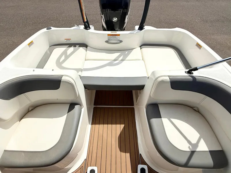 Slide: The Image of 2017 Bayliner Element E16 boat interior with cushioned seating and wood-style flooring. - 14