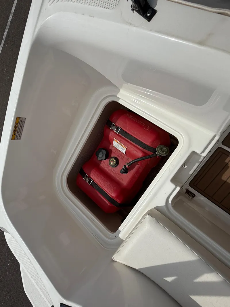 Slide: The Image of 2017 Bayliner Element E16 boat storage compartment with red fuel tank. - 15