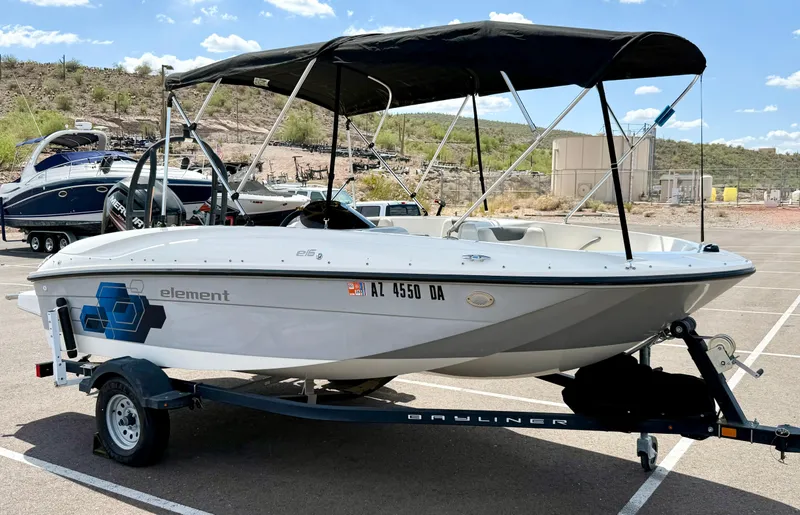 Slide: The Image of 2017 Bayliner Element E16 boat on trailer with canopy in parking lot. - 3