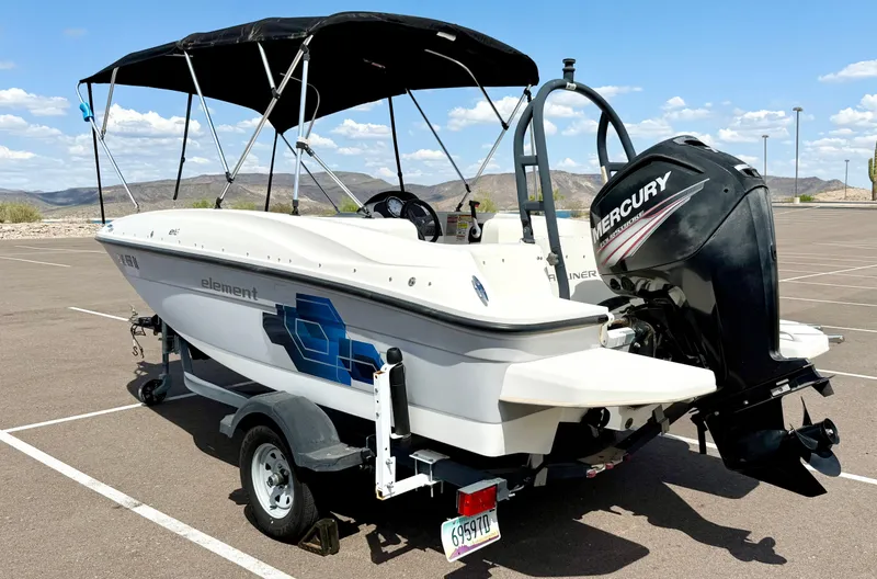 Slide: The Image of 2017 Bayliner Element E16 boat with Mercury engine on trailer in parking lot. - 4