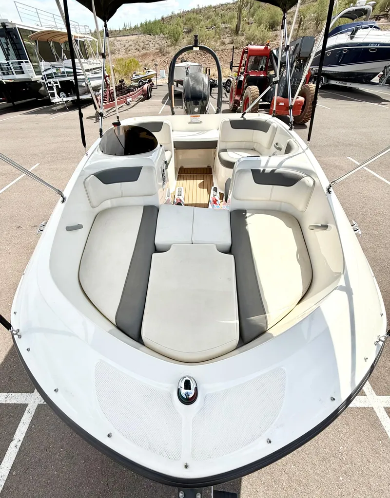 Slide: The Image of 2017 Bayliner Element E16 boat with spacious seating, parked outdoors. - 6