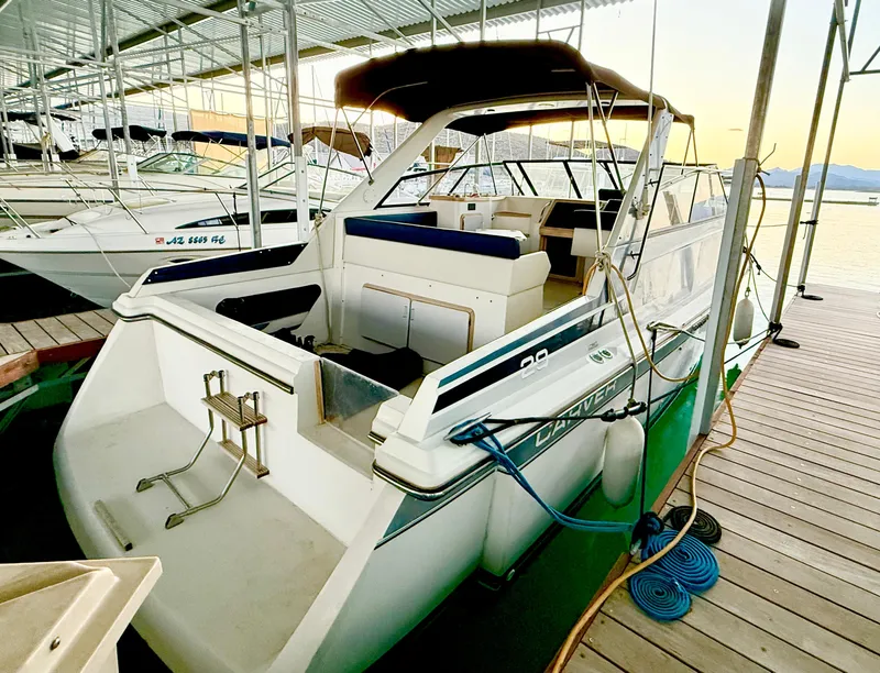 Slide: The Image of 1986 Carver 29 Monterey boat docked in a marina at sunset. - 1