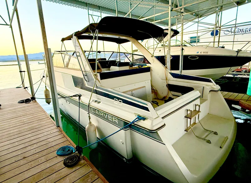 Slide: The Image of 1986 Carver 29 Monterey boat docked in a marina, side view. - 2