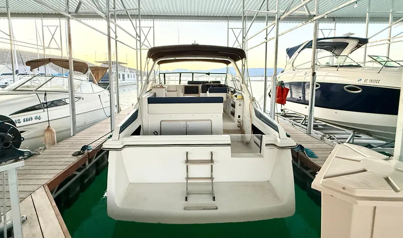 Slide: The Image of 1986 Carver 29 Monterey docked in a marina, rear view with ladder. - 3