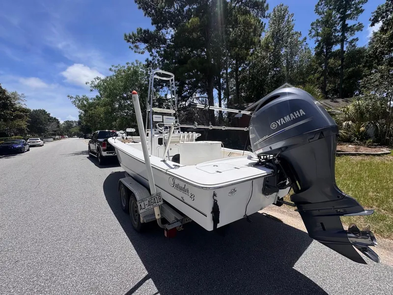 Slide: The Image of 2018 Intruder 23 SKIFF boat with Yamaha engine on a trailer, parked on a sunny street. - 3