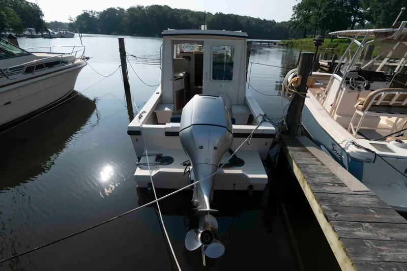 Slide: The Image of 2006 Rosborough RF-246 Sedan Cruiser docked with outboard motor. - 10