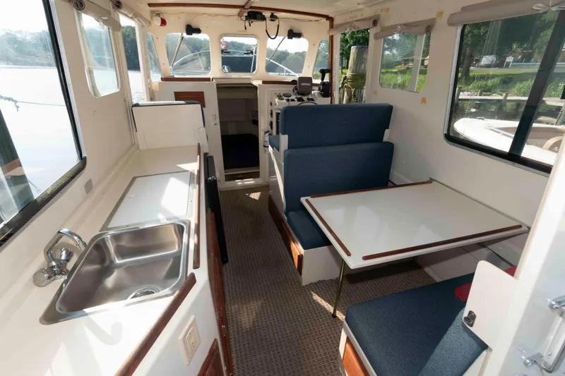 Slide: The Image of 2006 Rosborough RF-246 Sedan Cruiser interior with kitchenette, seating, and helm. - 11
