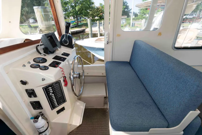 Slide: The Image of 2006 Rosborough RF-246 Sedan Cruiser interior with helm, controls, and blue seating. - 12