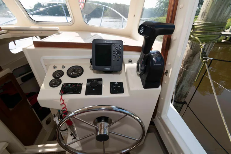 Slide: The Image of 2006 Rosborough RF-246 Sedan Cruiser helm with steering wheel, gauges, and navigation equipment. - 13