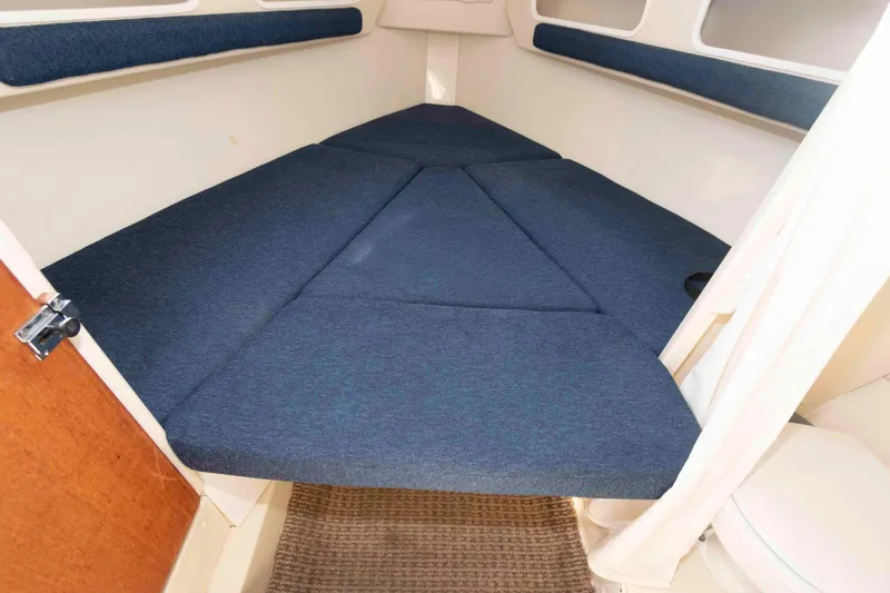 Slide: The Image of 2006 Rosborough RF-246 Sedan Cruiser interior with blue cushioned V-berth. - 15