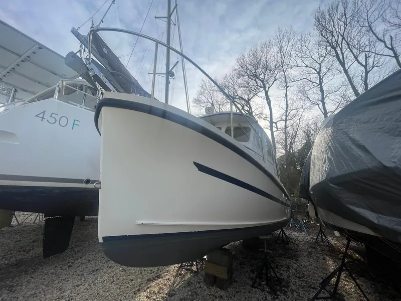 Slide: The Image of 2006 Rosborough RF-246 Sedan Cruiser on dry dock, surrounded by other boats. - 3