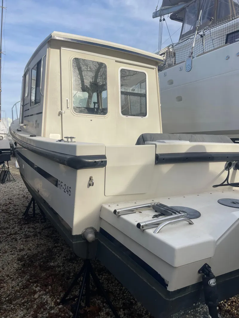 Slide: The Image of 2006 Rosborough RF-246 Sedan Cruiser on stands, rear view, in a boatyard. - 5