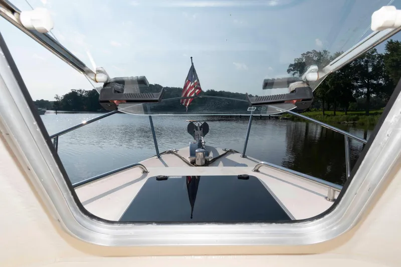 Slide: The Image of 2006 Rosborough RF-246 Sedan Cruiser on calm lake, viewed from cabin window. - 7