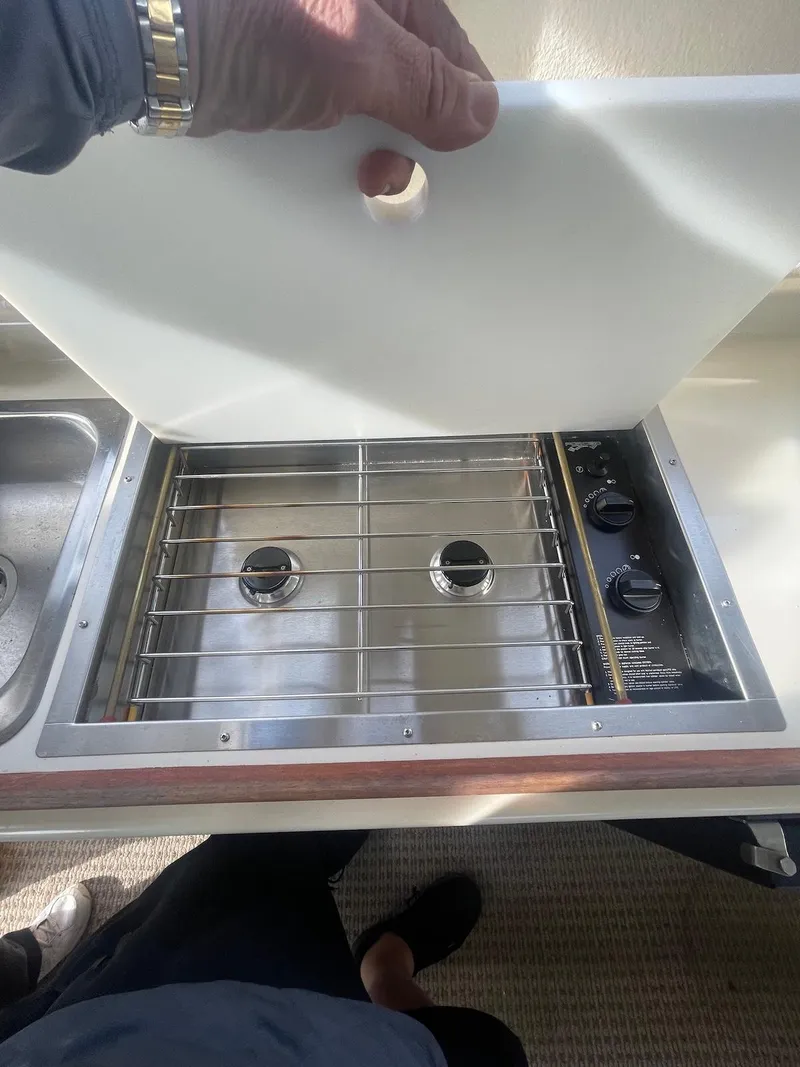 Slide: The Image of 2006 Rosborough RF-246 Sedan Cruiser stove with cover, featuring dual burners and control knobs. - 8