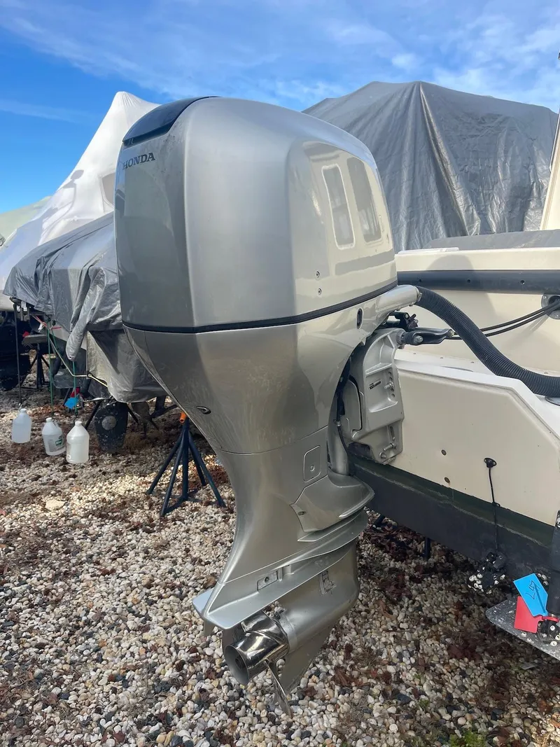 Slide: The Image of 2006 Rosborough RF-246 Sedan Cruiser with Honda outboard motor on gravel surface. - 9