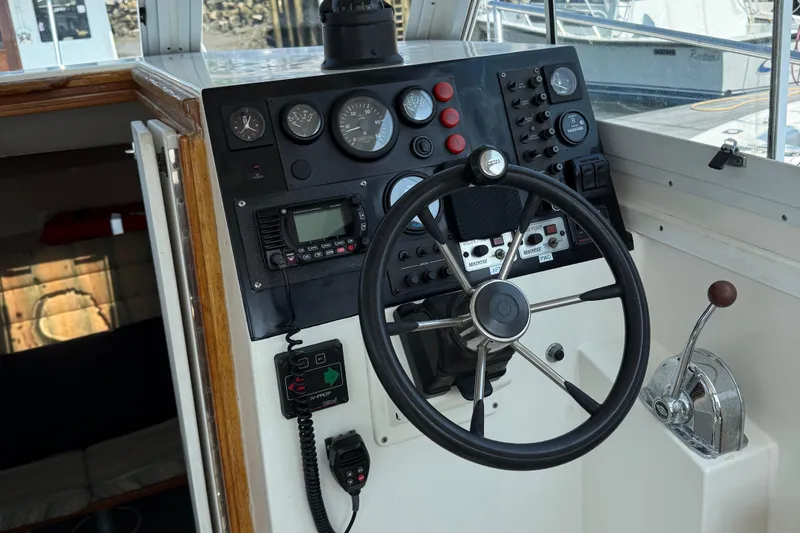 Slide: The Image of 1994 Albin 28 Tournament Express helm with steering wheel and control panel. - 14