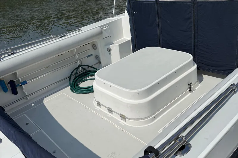 Slide: The Image of 1994 Albin 28 Tournament Express boat deck with storage and hose. - 18