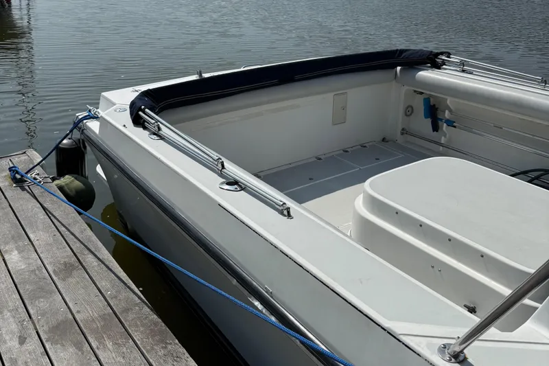 Slide: The Image of 1994 Albin 28 Tournament Express boat docked by the water. - 3