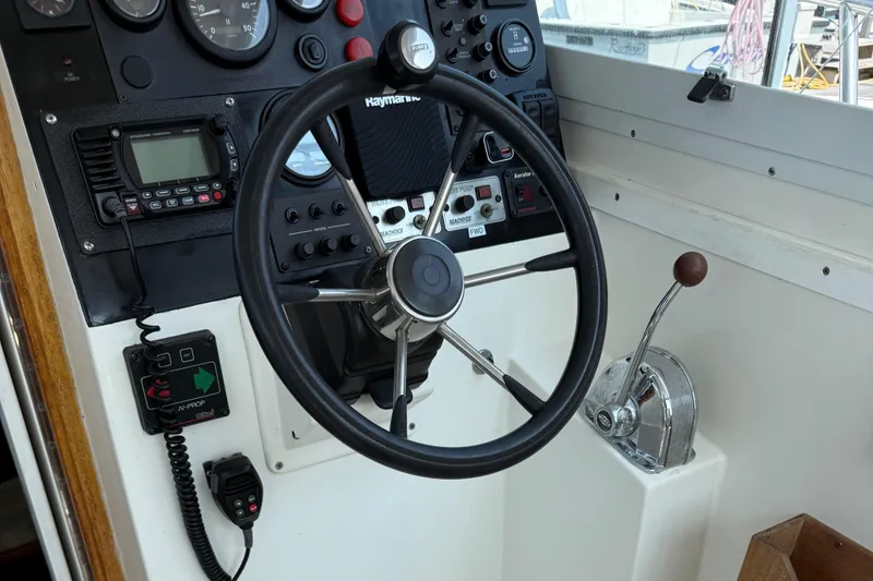 Slide: The Image of 1994 Albin 28 Tournament Express helm with steering wheel and control panel. - 4