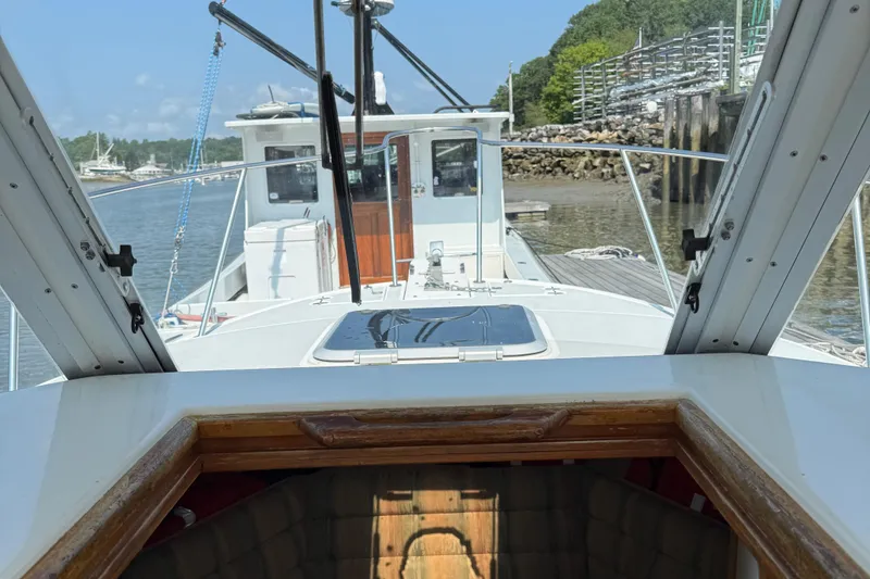 Slide: The Image of 1994 Albin 28 Tournament Express boat docked, view from cabin towards deck and water. - 6
