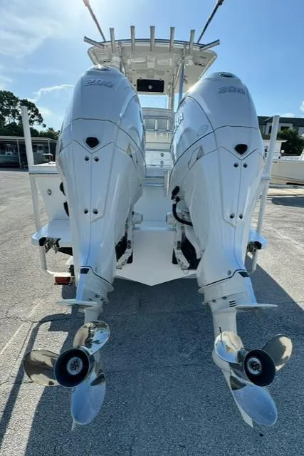 Slide: The Image of 2026 Pair Customs 24 Center Console DV with dual outboard engines, rear view. - 13
