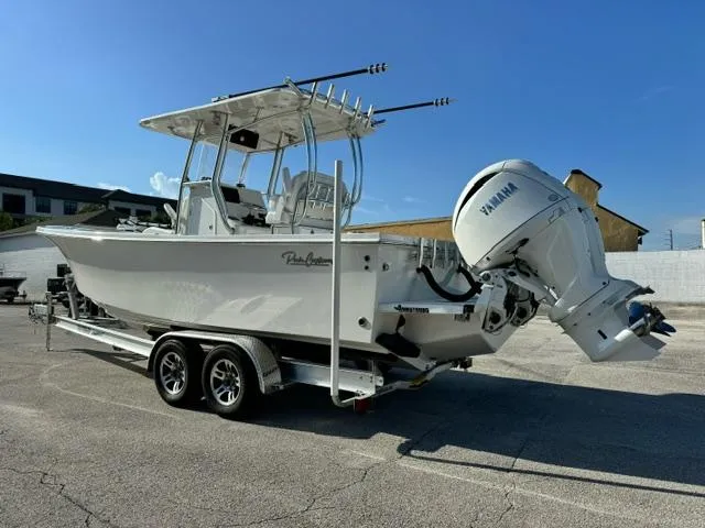 Slide: The Image of 2026 Pair Customs 24 Center Console DV boat with Yamaha engine on trailer. - 2