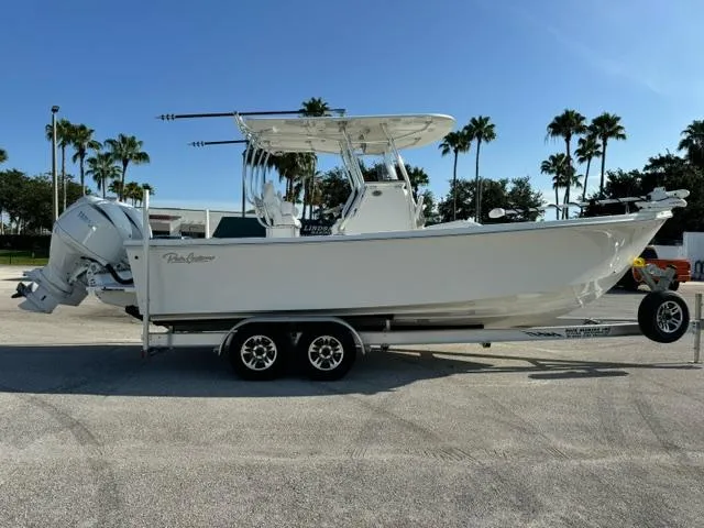 Slide: The Image of 2026 Pair Customs 24 Center Console DV boat on trailer, parked outdoors. - 4