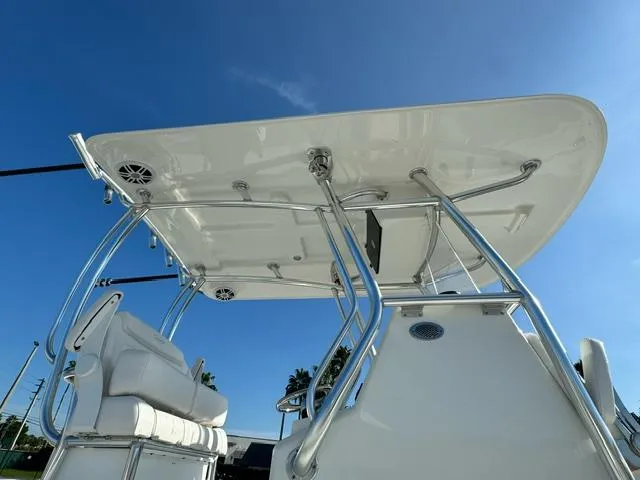Slide: The Image of 2026 Pair Customs 24 Center Console DV boat with sleek T-top and seating, under clear blue sky. - 7