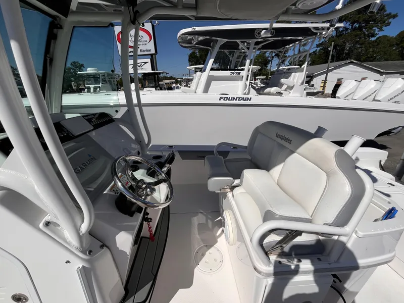 Slide: The Image of 2017 Everglades 273 Center Console boat interior with steering wheel and seating. - 13