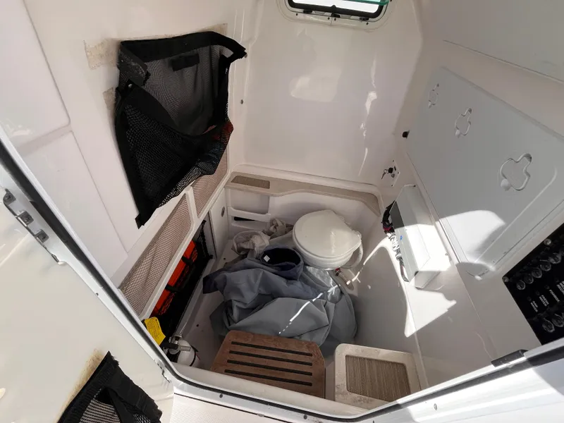 Slide: The Image of Interior of 2017 Everglades 273 Center Console boat with storage and toilet. - 14