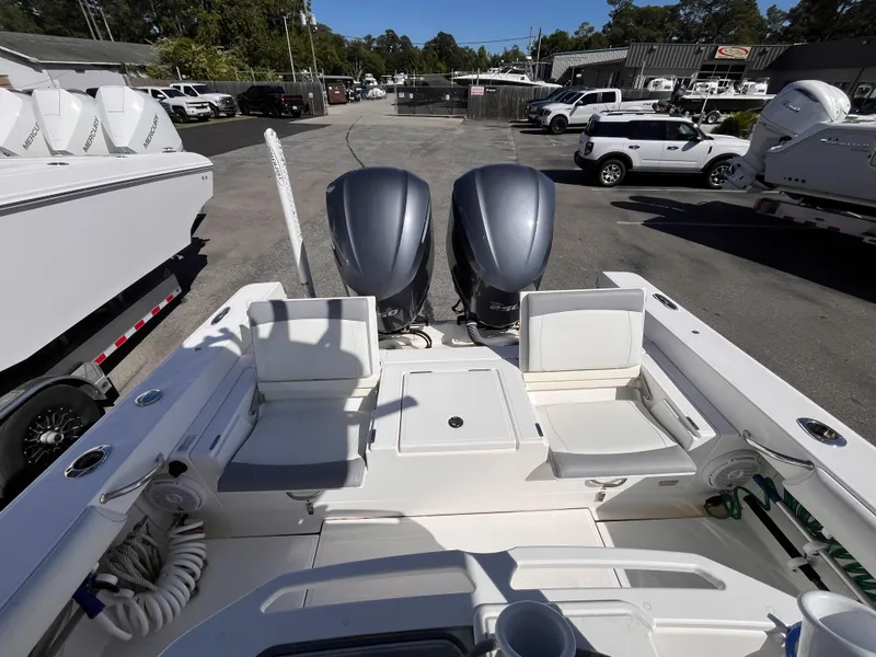 Slide: The Image of 2017 Everglades 273 Center Console boat with dual engines, parked in a marina lot. - 15