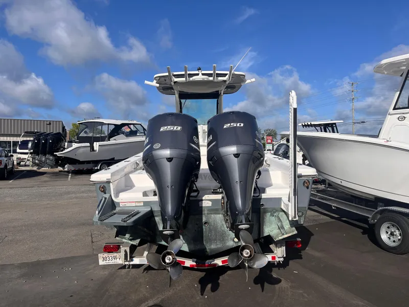 Slide: The Image of 2017 Everglades 273 Center Console boat with dual Yamaha 250 engines, parked outdoors. - 3