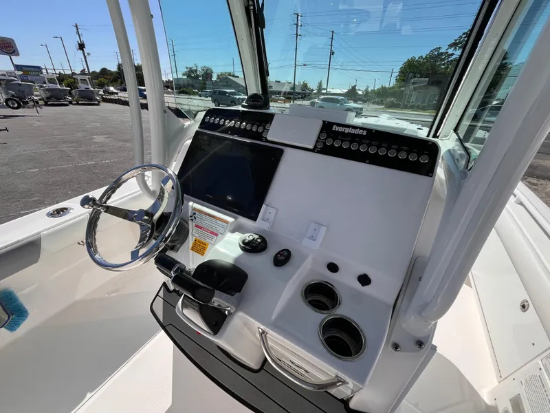 Slide: The Image of 2017 Everglades 273 Center Console boat dashboard with steering wheel and controls. - 7
