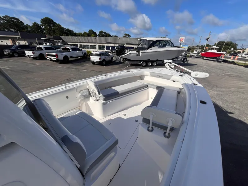 Slide: The Image of 2017 Everglades 273 Center Console boat in a dealership lot under a clear blue sky. - 9