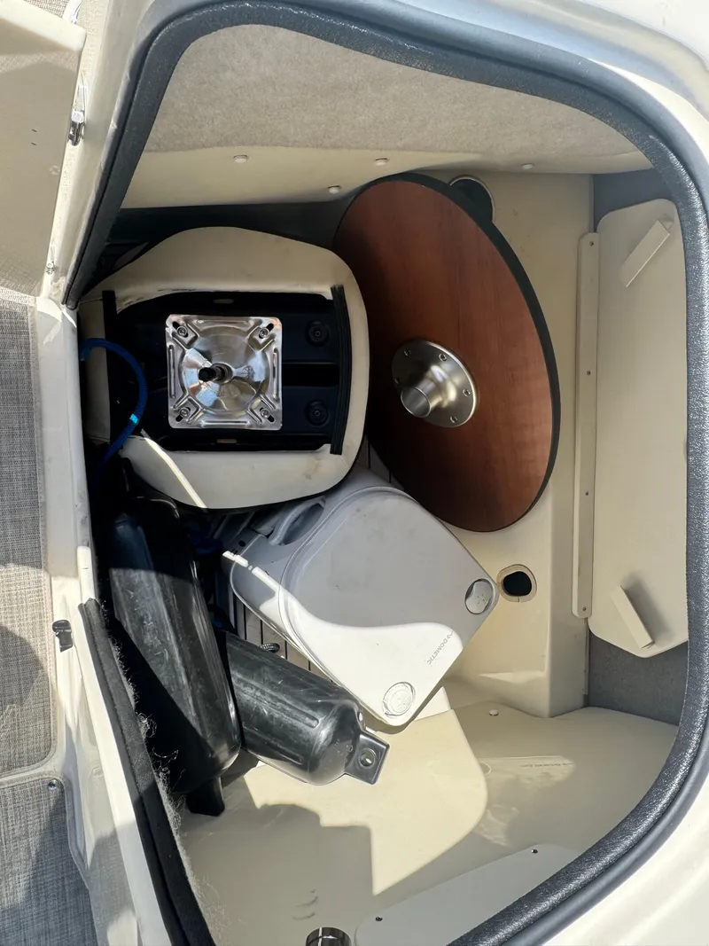Slide: The Image of Storage compartment of 2021 Stingray 212 SC boat with various equipment and accessories. - 11