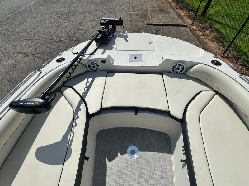 Slide: The Image of 2021 Stingray 212 SC boat interior with seating and trolling motor. - 12
