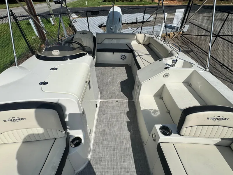 Slide: The Image of 2021 Stingray 212 SC boat interior with spacious seating and modern design. - 13