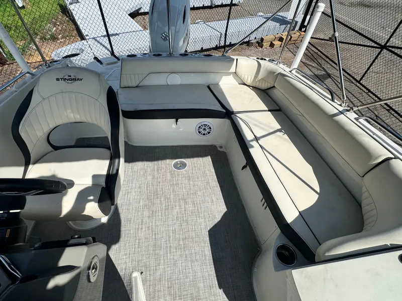 Slide: The Image of 2021 Stingray 212 SC boat interior with spacious seating and modern design. - 14