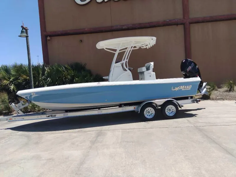 The Image of 2025 Mako 24 APEX boat on trailer, blue hull, parked outdoors. - 0