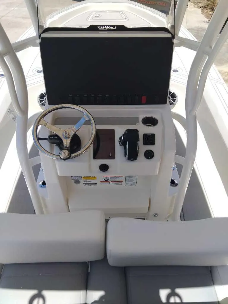 Slide: The Image of 2025 Mako 24 APEX boat console with steering wheel and controls. - 4
