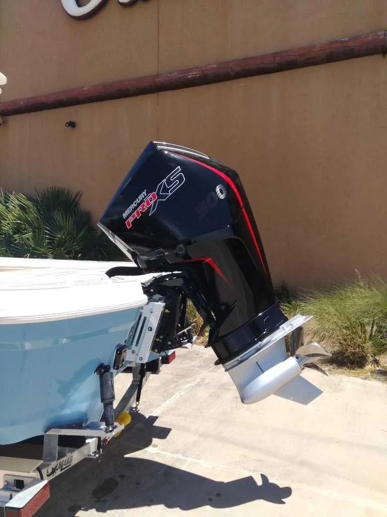 Slide: The Image of 2025 Mako 24 APEX boat with Mercury Pro XS outboard motor. - 5