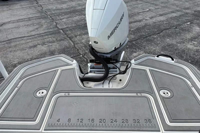 Slide: The Image of 2025 Mako 24 APEX boat with Mercury engine on textured deck. - 8