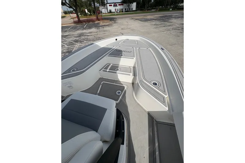 Slide: The Image of 2025 Mako 24 APEX boat deck with seating and storage compartments. - 11