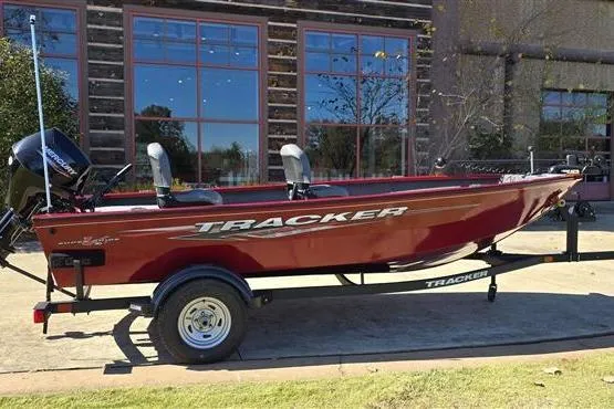 The Image of 2025 Tracker Super Guide V-16 T boat, red, parked outdoors on a trailer. - 0