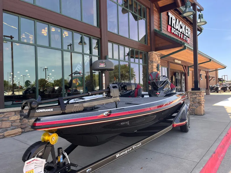 Slide: The Image of 2025 Ranger Z521 boat displayed outside Tracker Boats & ATVs store. - 2