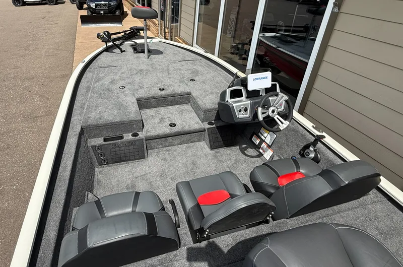 Slide: The Image of 2025 Tracker Savage 215 boat interior with steering console and seating. - 3