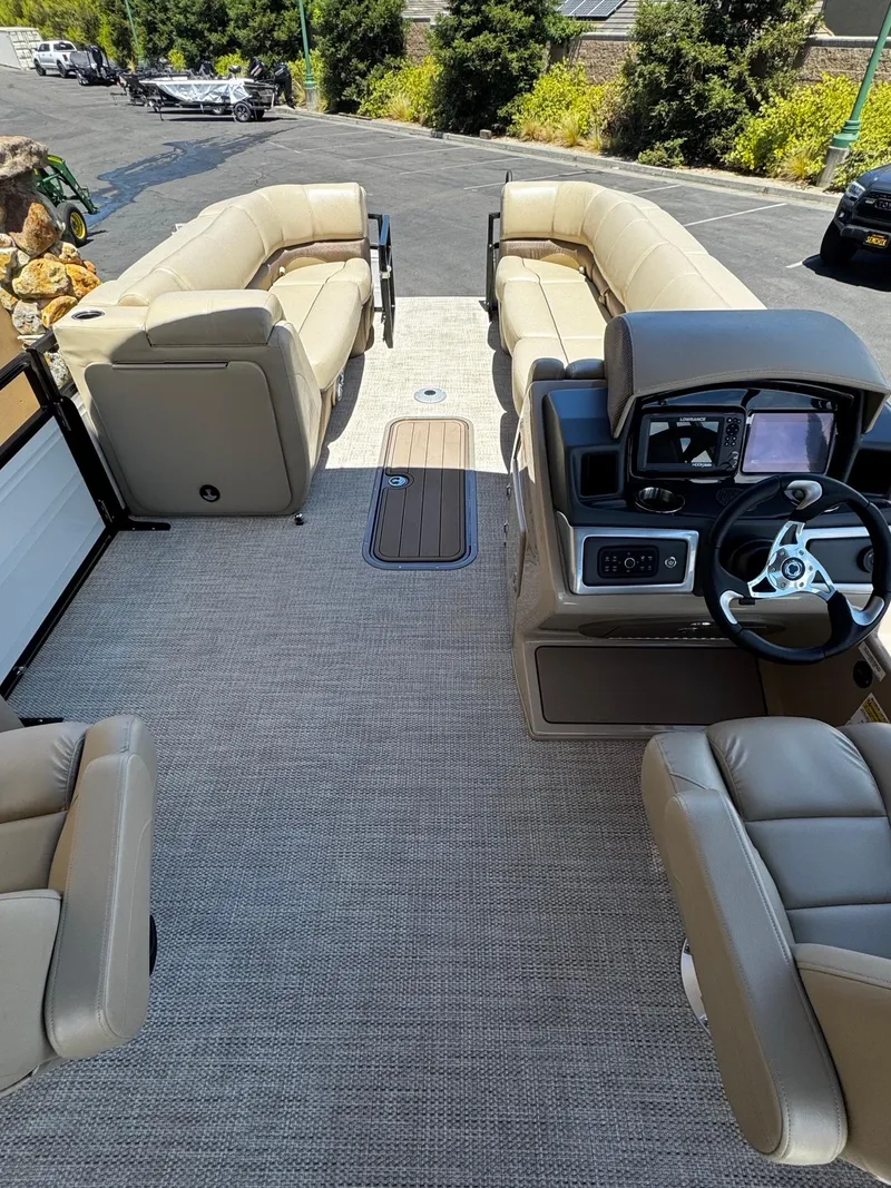 Slide: The Image of 2025 Regency 250 DL3 pontoon boat interior with beige seating and modern helm. - 4